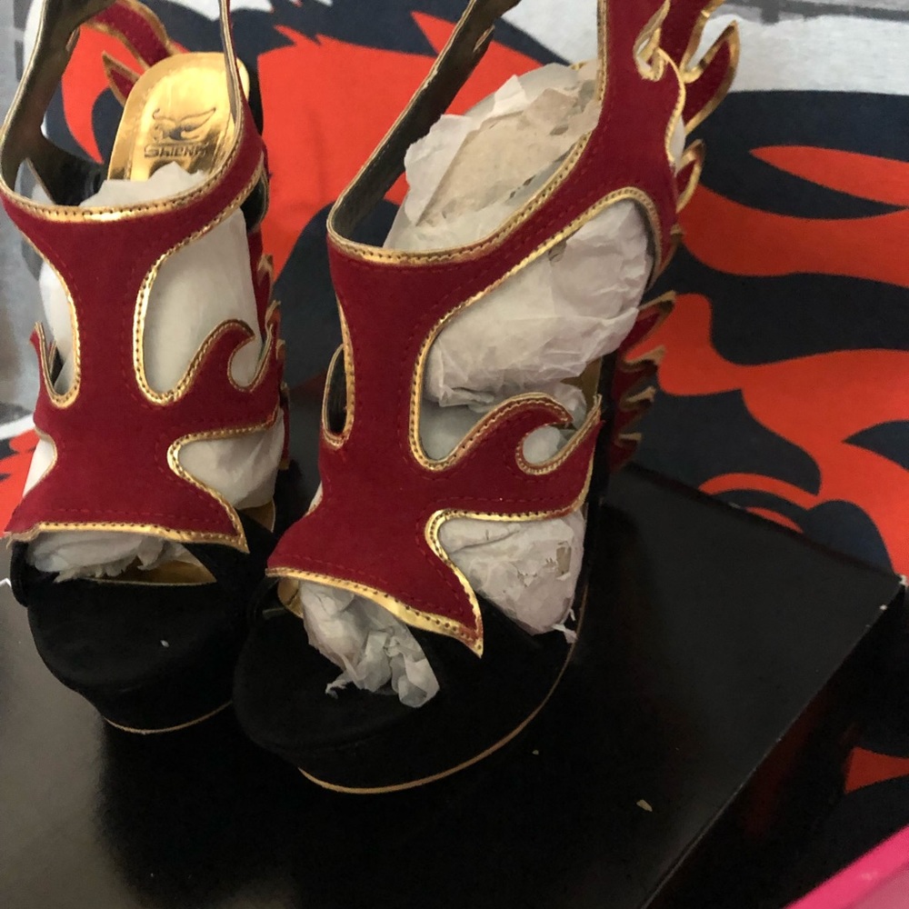 two pair black and black and red heal sandals
